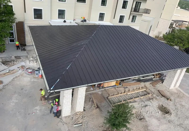Metal roofing installation team working on a commercial building in Berkeley